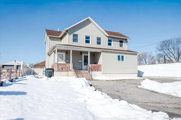 a view of a house with snow in the background