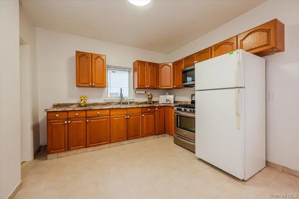 a kitchen with a refrigerator and a sink