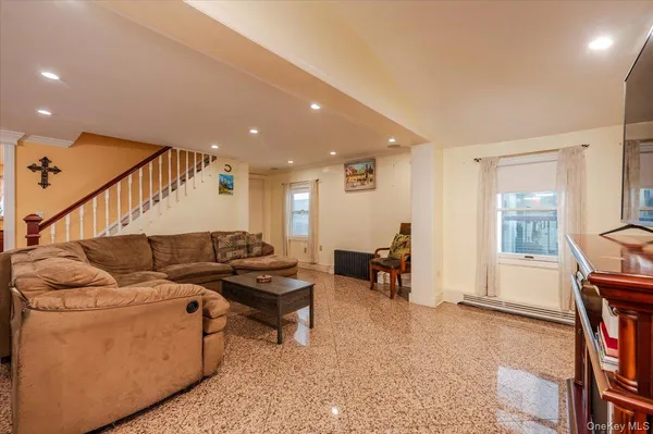 a living room with furniture and a piano