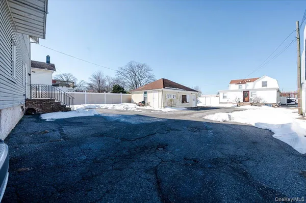 a view of a house with snow on the road