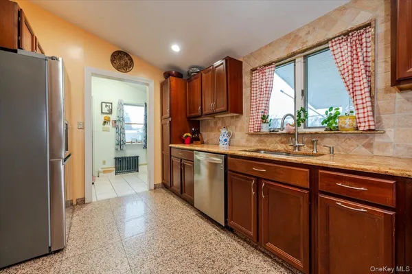 a kitchen with stainless steel appliances granite countertop a refrigerator and a sink