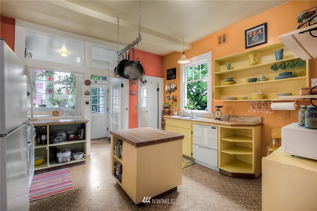 529 19th Avenue Seattle, WA 98122 - Photo 15 of 39 a kitchen with stainless steel appliances kitchen island granite countertop a stove and a sink