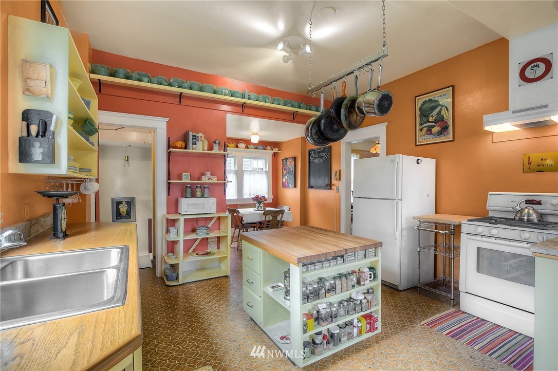 529 19th Avenue Seattle, WA 98122 - Photo 16 of 39 a kitchen with stainless steel appliances granite countertop a stove and a refrigerator