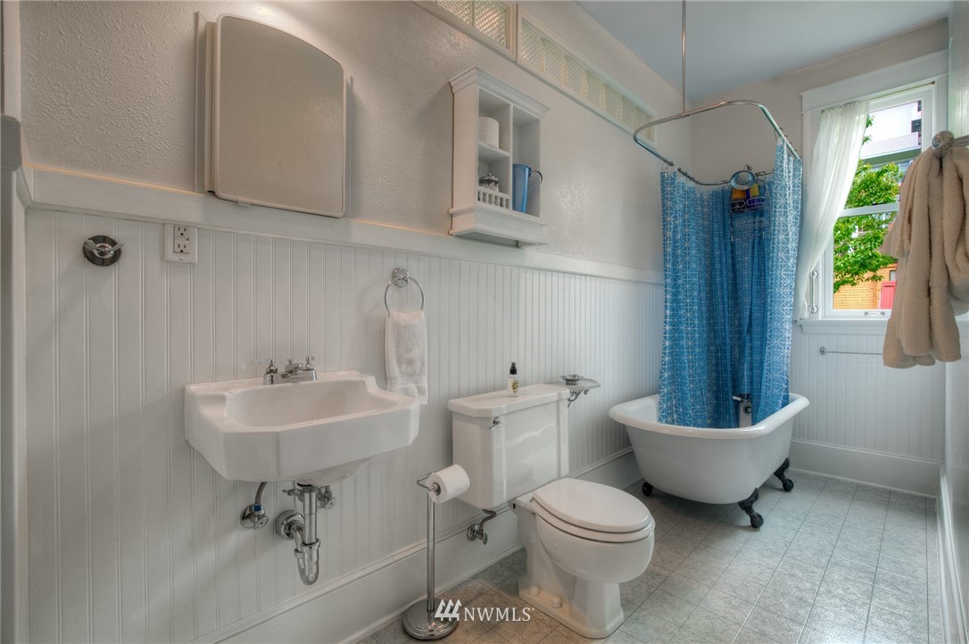 529 19th Avenue Seattle, WA 98122 - Photo 27 of 39 a bathroom with a sink toilet a mirror and bathtub