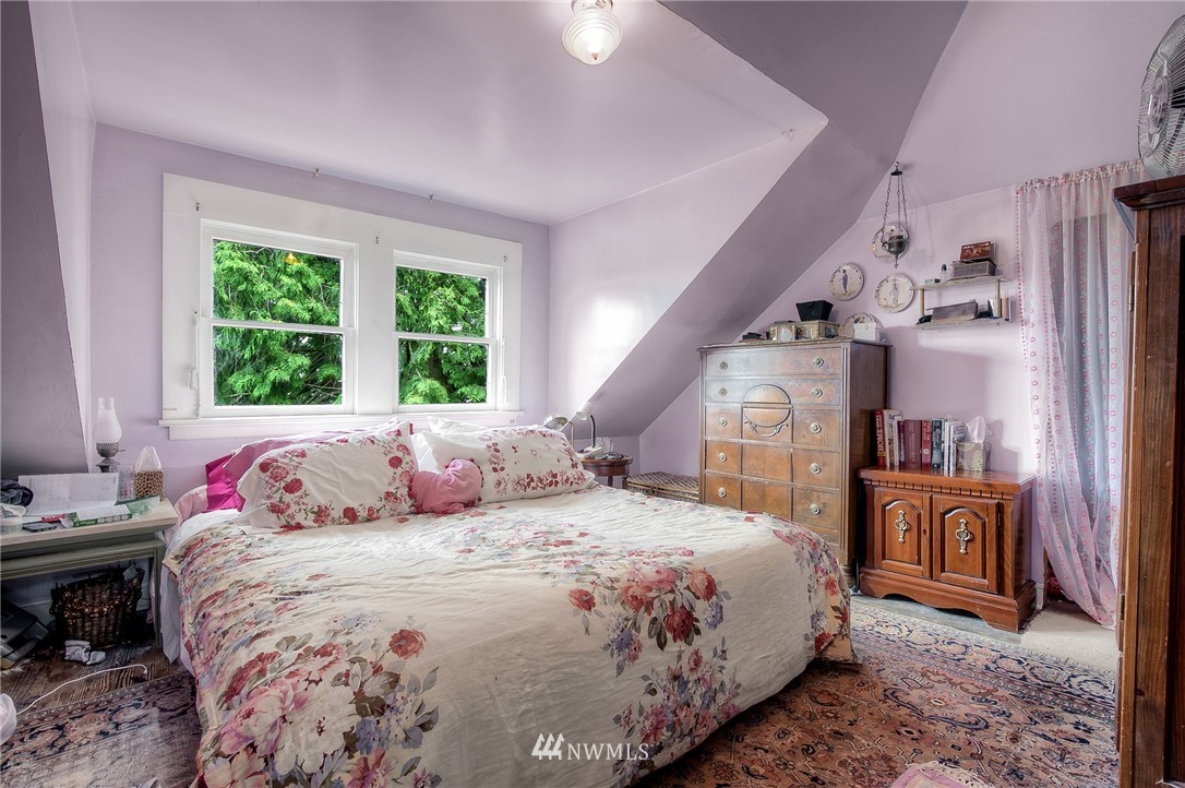 529 19th Avenue Seattle, WA 98122 - Photo 30 of 39 a bedroom with a bed and a chandelier