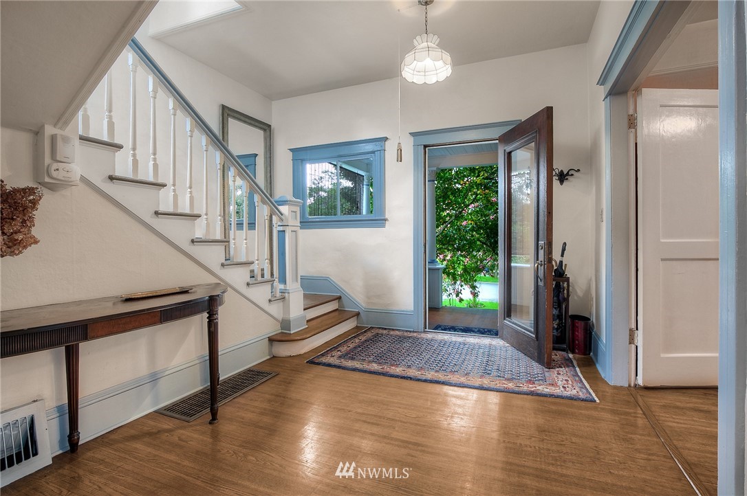 529 19th Avenue Seattle, WA 98122 - Photo 5 of 39 a view of an entryway with wooden floor staircase and a living room