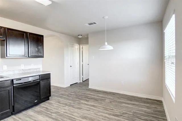 a view of a kitchen with a stove top oven