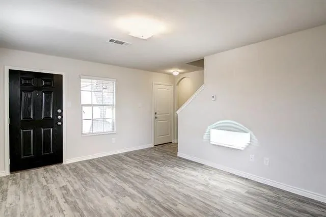 an empty room with windows and closet