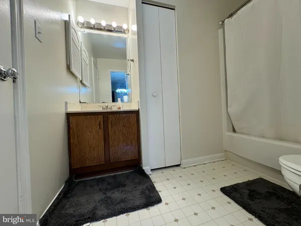 a bathroom with a sink a toilet a shower and a mirror