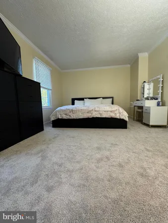 a bedroom with a bed and dresser
