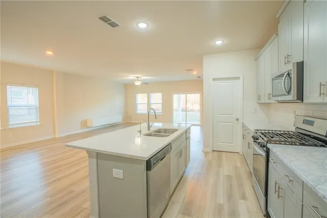 a kitchen with a sink stove and wooden cabinets