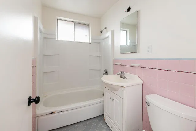 a bathroom with a sink toilet vanity and bathtub