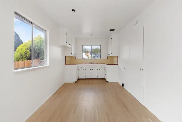a view of a kitchen with a sink and a window