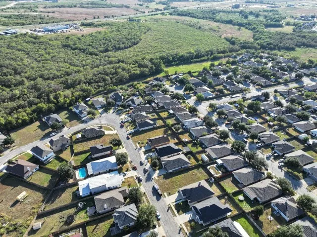 an aerial view of residential houses with outdoor space