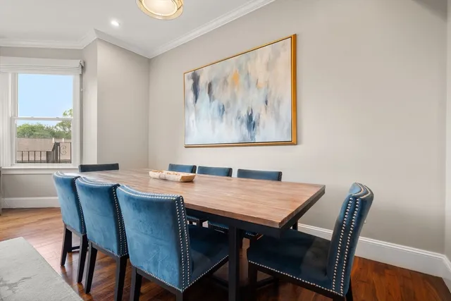 a view of a dining room with furniture window and wooden floor