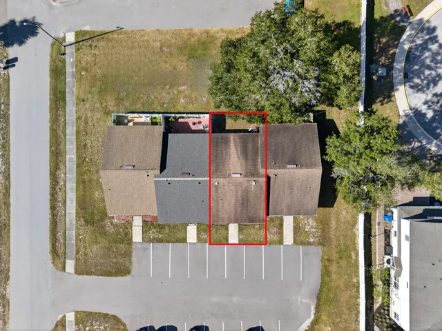 an aerial view of a house with a yard