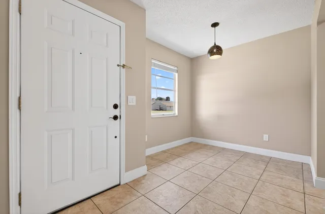 a view of an empty room with closet area
