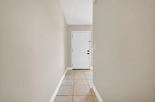 a kitchen with a refrigerator sink and cabinets