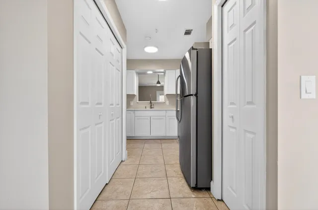 a view of a kitchen with white cabinets