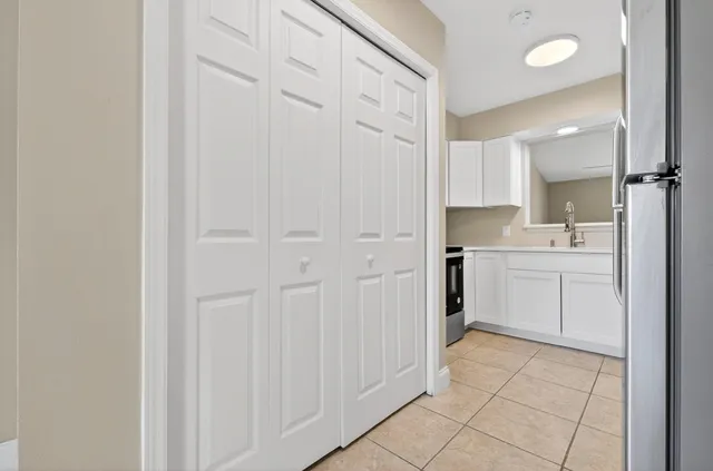 a utility room with cabinets washer and dryer
