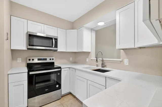 a white refrigerator freezer sitting inside of a kitchen