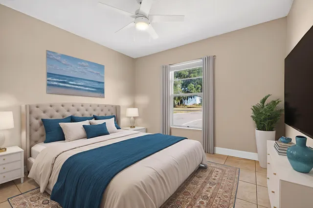 a bedroom with a large bed and a flat screen tv