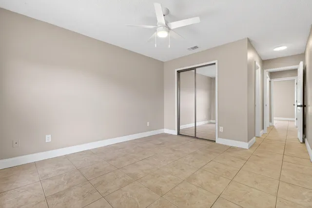 a spacious bedroom with a bed and a window