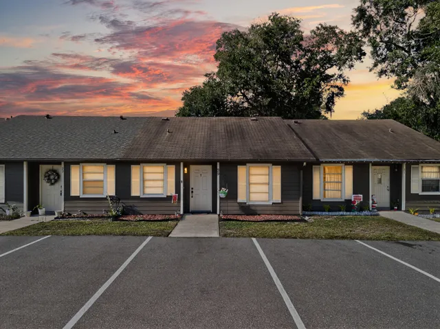 a front view of house with yard and trees