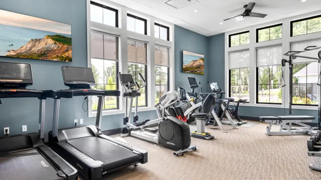 a room with gym equipment and a large window