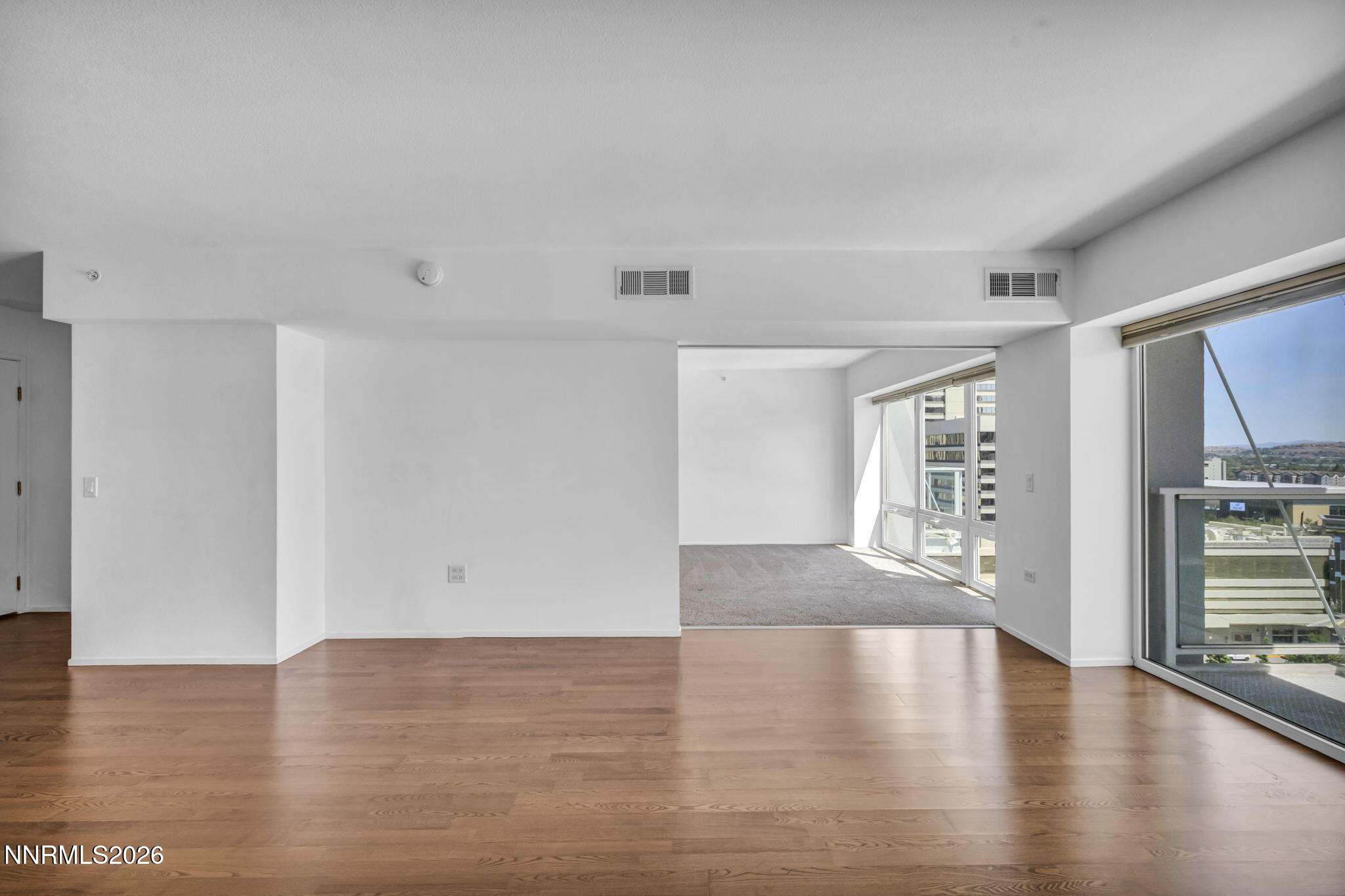 255 North Sierra Street, Unit 1208 Reno, NV 89501 - Photo 7 of 37 a view of an empty room with wooden floor and a window