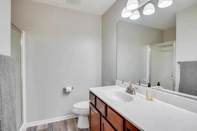 a bathroom with a sink toilet and a mirror