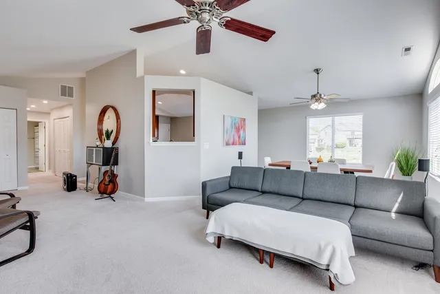a living room with furniture and a gym
