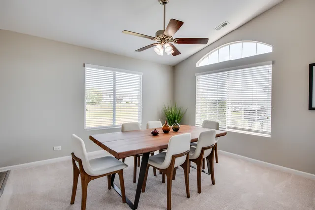 a view of a dining room with furniture and window
