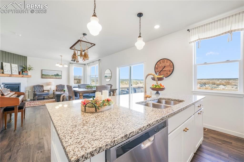 15882 Little Bluestem Road Monument, CO 80132 - Photo 11 of 50 Kitchen with gas range, stainless appliances, walk in pantry, granite countertops, large center island, under cabinet lighting