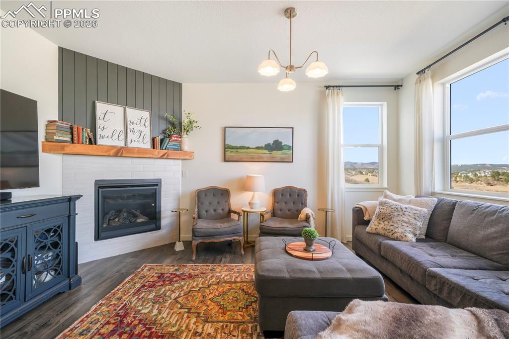 15882 Little Bluestem Road Monument, CO 80132 - Photo 18 of 50 Main level living room with abundant light, gas fireplace