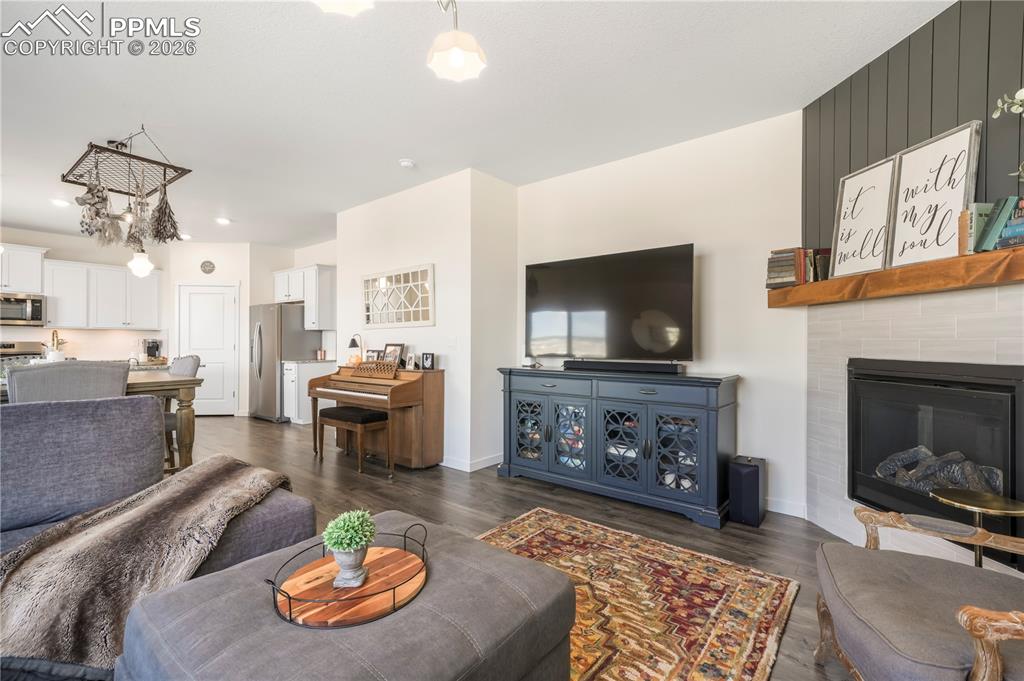15882 Little Bluestem Road Monument, CO 80132 - Photo 19 of 50 Main level living room with abundant light, gas fireplace