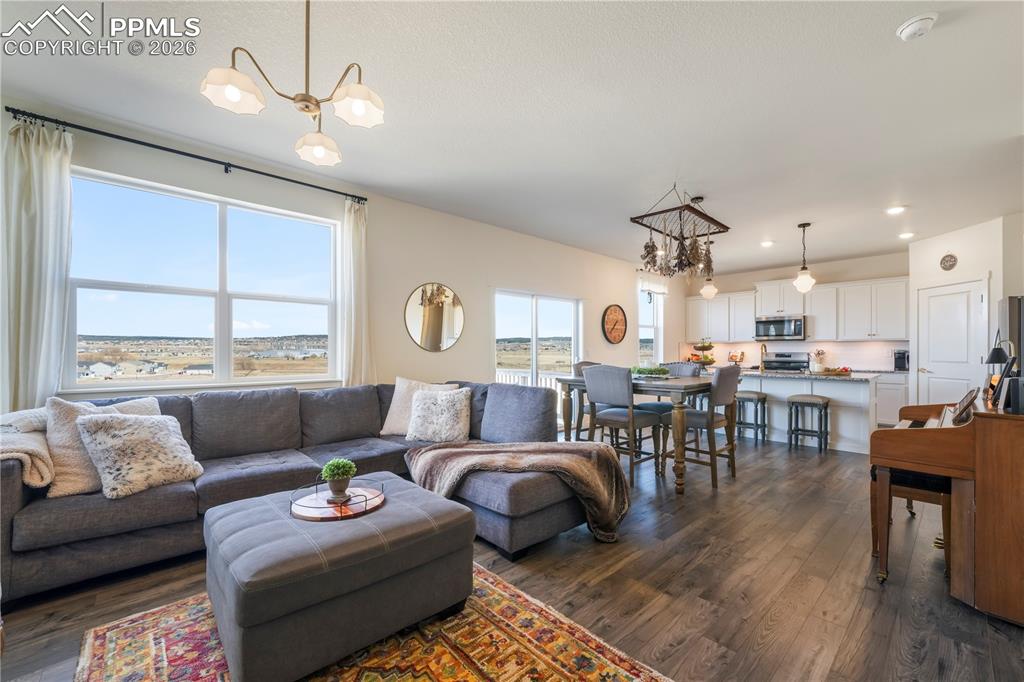 15882 Little Bluestem Road Monument, CO 80132 - Photo 20 of 50 Main level living room with abundant light, gas fireplace