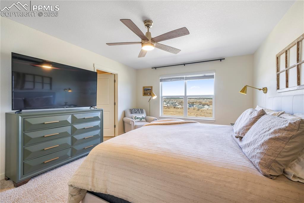 15882 Little Bluestem Road Monument, CO 80132 - Photo 23 of 50 Upstairs primary bedroom with space for seating area, ensuite bathroom and views