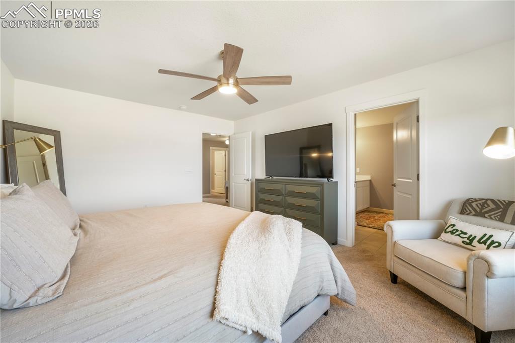 15882 Little Bluestem Road Monument, CO 80132 - Photo 24 of 50 Upstairs primary bedroom with space for seating area, ensuite bathroom and views