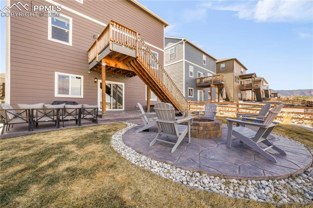 15882 Little Bluestem Road Monument, CO 80132 - Photo 45 of 50 Backyard with gas firepit, fenced yard, tiered stamp concrete patio areas and hot tub