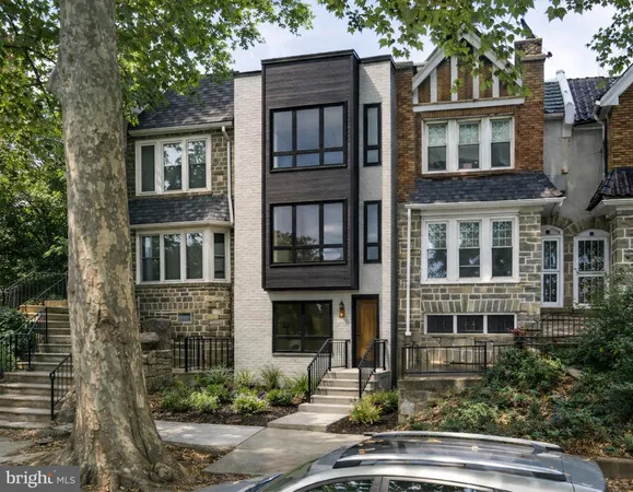 a front view of residential houses with yard