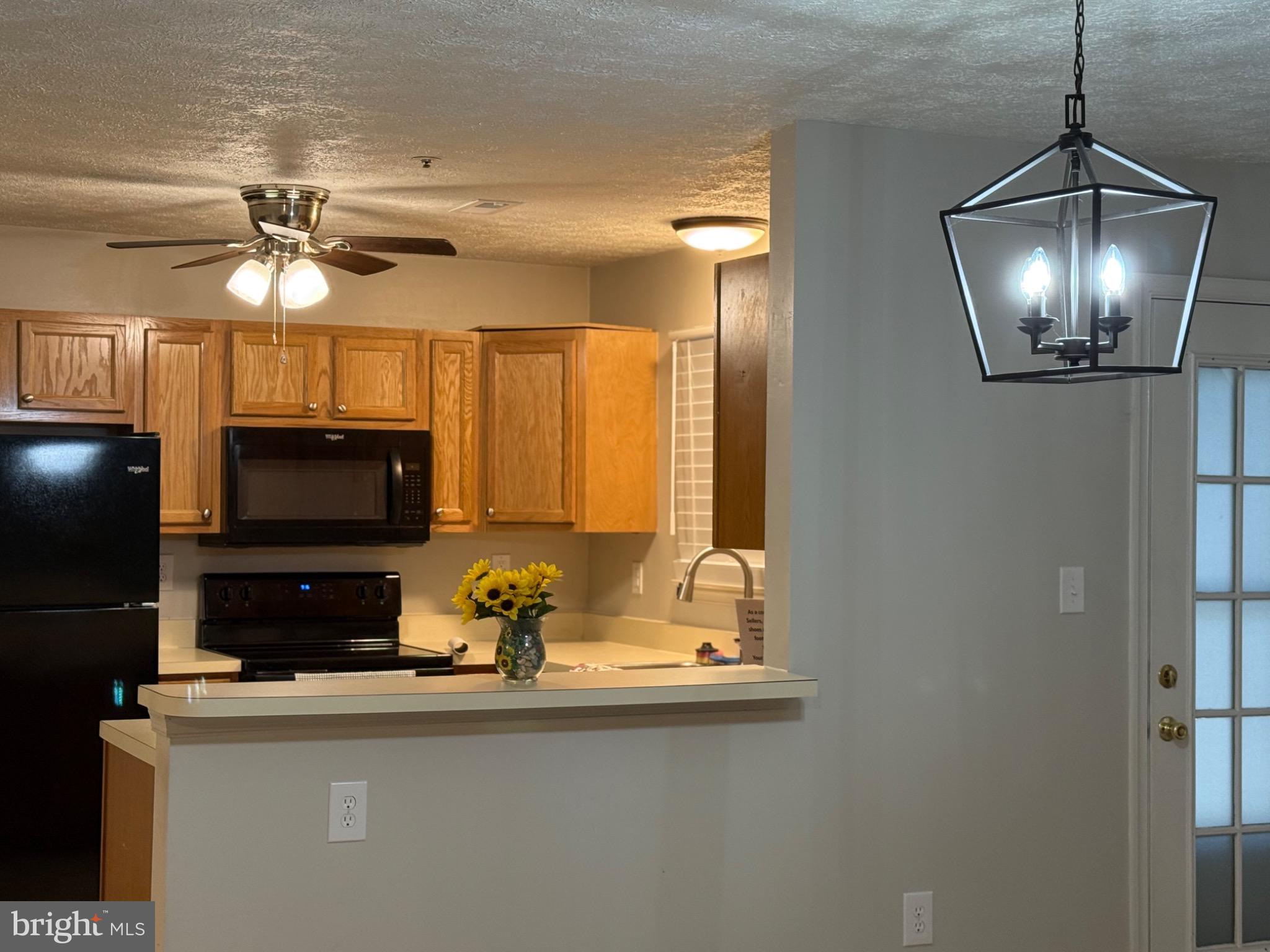 38 Jumpers Circle, Unit 253 Nottingham, MD 21236 - Photo 11 of 31 a kitchen with stainless steel appliances a stove refrigerator and microwave
