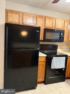 38 Jumpers Circle, Unit 253 Nottingham, MD 21236 - Photo 9 of 31 a kitchen with a refrigerator and a microwave