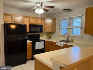 38 Jumpers Circle, Unit 253 Nottingham, MD 21236 - Photo 10 of 31 a kitchen with stainless steel appliances granite countertop a sink refrigerator stove and microwave