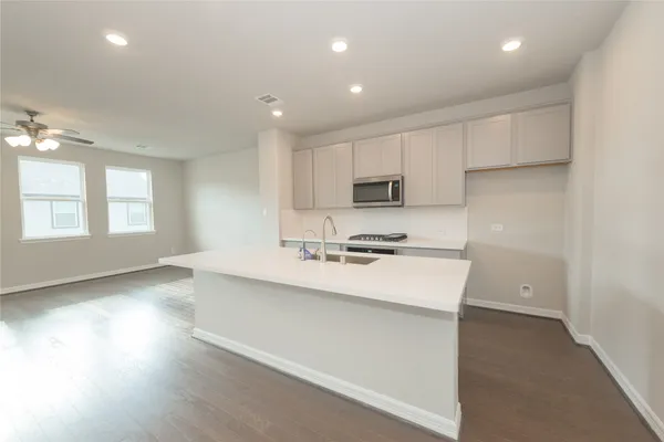 a kitchen with a sink stove and cabinets