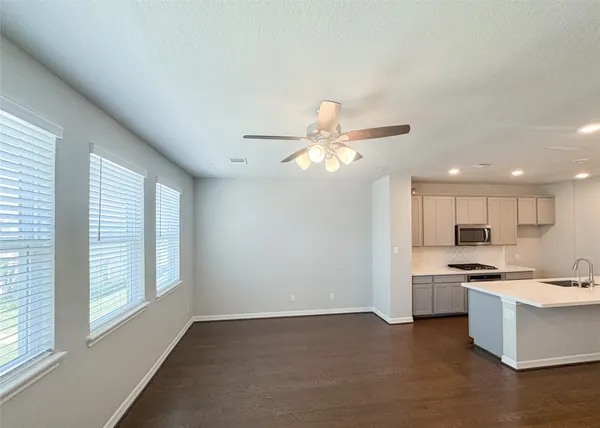 a kitchen with stainless steel appliances kitchen island granite countertop a stove a sink and a refrigerator