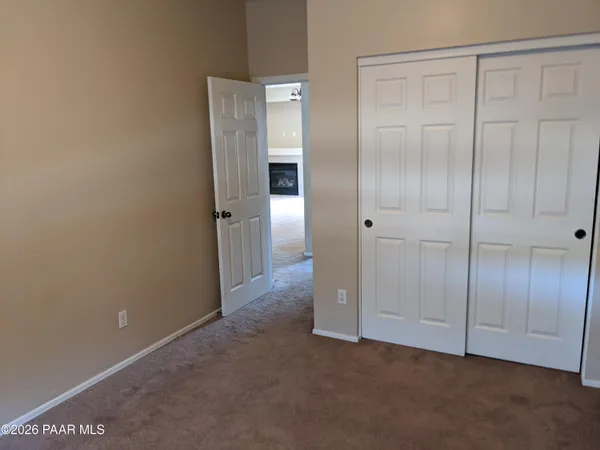 a bathroom with a granite countertop sink toilet and a window