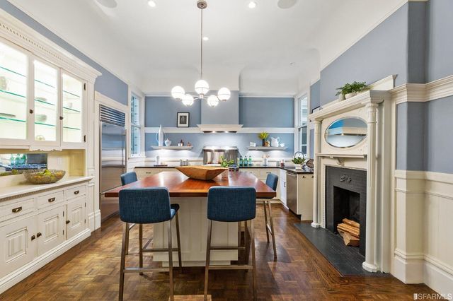 a large kitchen with a table and chairs