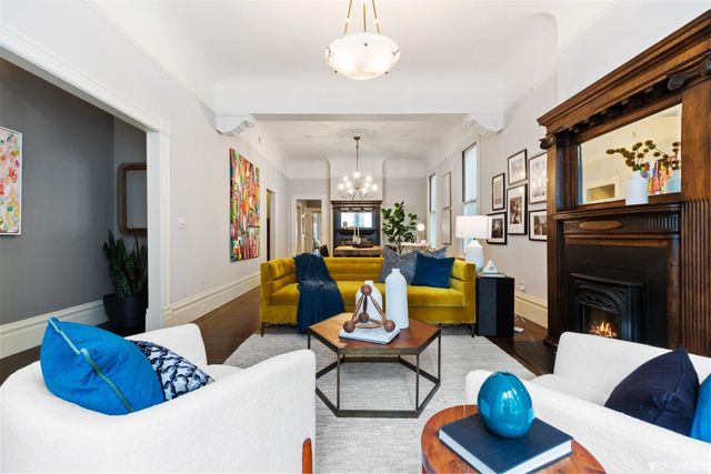 a living room with furniture a fireplace and a flat screen tv