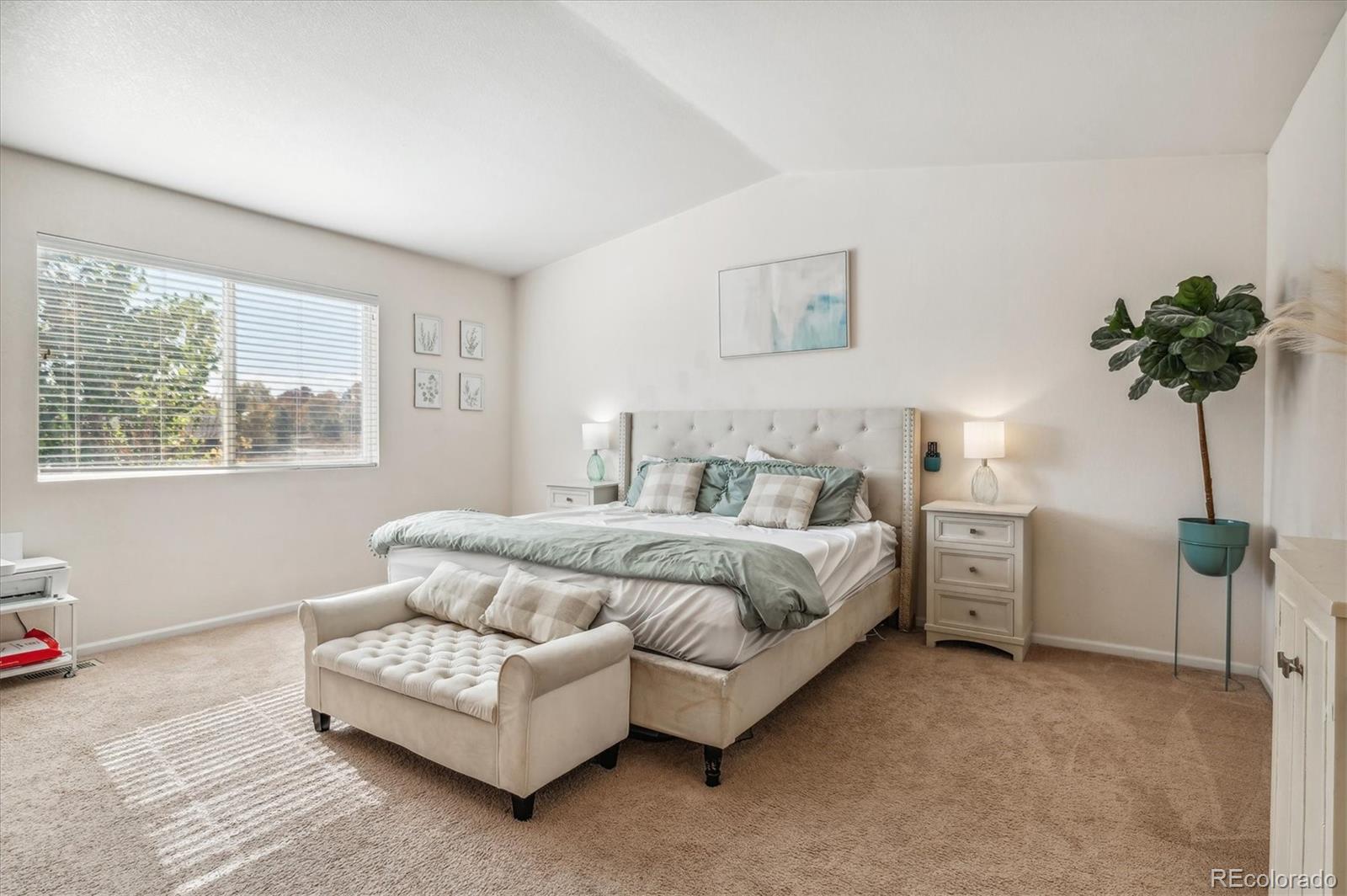 1345 Trail Ridge Road Longmont, CO 80504 - Photo 12 of 25 a spacious bedroom with a bed and a couch